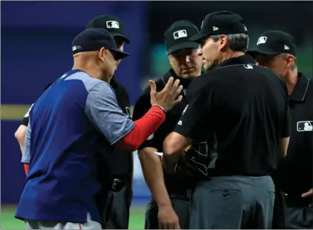  ?? THE ASSOCIATED PRESS ?? Manager Alex Cora #20 of the Boston Red Sox talks with the umpire crew about a defensive switch in the eighth inning during a game against the Tampa Bay Rays at Tropicana Field on July 24, 2019 in St Petersburg, Florida.