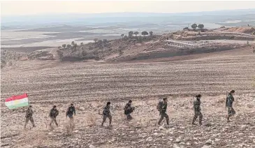  ?? NYT ?? Female Kurdish fighters walk to their mountainsi­de base in the Kurdistan Region of Iraq on Tuesday.