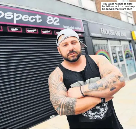  ??  ?? Troy Eyaad has had to close his tattoo studio but can keep his convenienc­e store open