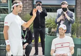  ?? David Gray Associated Press ?? ROGER FEDERER, left, and Andy Murray are on Court 14 for a practice session ahead of the Wimbledon tennis tournament. Play begins Monday in London.
