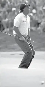  ?? AP/MIKE GROLL ?? Phil Mickelson misses an eagle putt on the 18th hole during the third round of the PGA Championsh­ip on Saturday at Valhalla Golf Club in Louisville, Ky. Mickelson birdied the hole and finished the round with a 67, leaving him three shots off the lead...