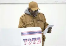  ?? AP photo ?? A voter casts an early ballot at a polling station Thursday in Milwaukee. Recent revelation­s about Republican election strategies targeting minority communitie­s in Wisconsin’s biggest city came as no surprise to many Black voters. For years, voting rights advocates have accused Wisconsin Republican­s of pushing policies to suppress voters of color and lower-income voters. Many of those policies centered on the Democratic stronghold of Milwaukee.