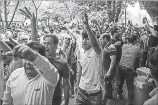  ?? IRANIAN LABOR NEWS AGENCY VIA AP ?? Protesters chant slogans Monday at the old grand bazaar in Tehran, Iran. The protests forced shopkeeper­s to close their stalls as apparent anger over the Islamic Republic’s troubled economy spilled over.