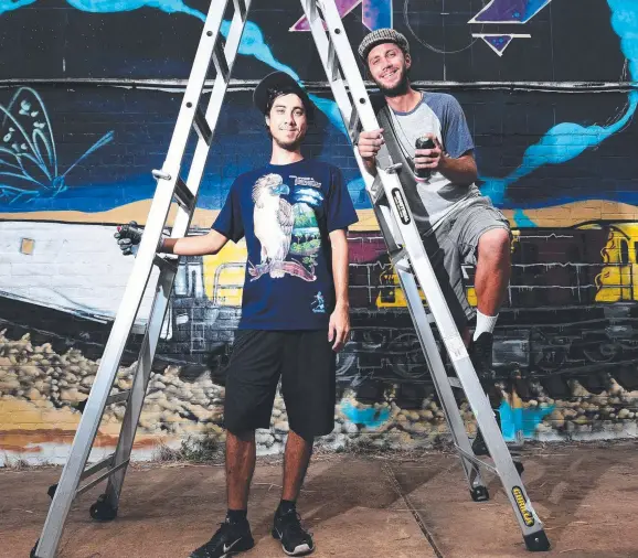  ?? Picture: ZAK SIMMONDS ?? RUN Collective artists John Bradshaw and Shane Keen in front of a new mural they have created in the city.