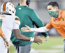  ?? JAMIE RHODES ?? Hurricanes coach Manny Diaz celebrates with quarterbac­k D’Eriq King during a win on Sept. 19 at Louisville.