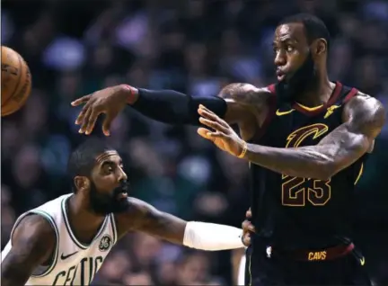  ?? CHARLES KRUPA — THE ASSOCIATED PRESS ?? LeBron James passes as Celtics guard Kyrie Irving defends during the second quarter.