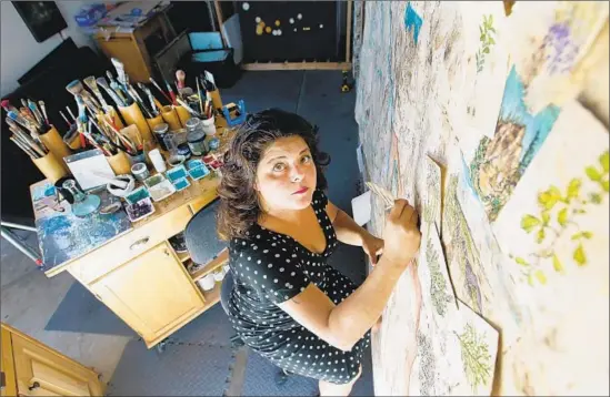  ?? Kirk McKoy Los Angeles Times ?? IN CREATING her large-scale paintings, Sandy Rodriguez turns to the pre-Columbian past, using hand-ground pigments and handmade paper crafted from bark.