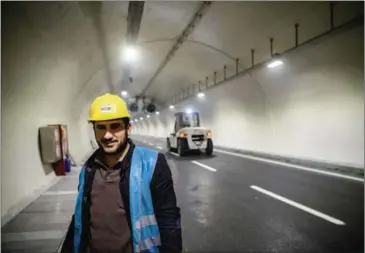  ?? OZAN KOSE/AFP ?? Constructi­on workers walk inside a new tunnel in Istanbul on December 16.