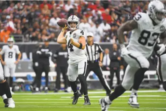  ?? Eric Christian Smith / Associated Press ?? Last season, Raiders quarterbac­k Derek Carr was sacked a careerhigh 51 times. This year, with a retooled offensive line, the sack total is only eight through seven games.