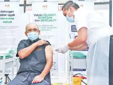  ??  ?? Kiandee receiving the Covid-19 vaccine at the Putrajaya Health Office in Precinct 11, yesterday.