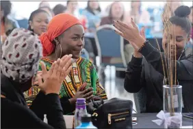  ?? DANA JENSEN/THE DAY ?? Nifemi Olugbemiga, center, a freshman from Chicago, is applauded Sunday as she returns to her seat after her spoken word performanc­e during the Black Women’s Conference at Connecticu­t College in New London.