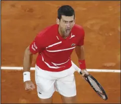  ?? Associated Press ?? LET’S GO! — Serbia’s Novak Djokovic screams after scoring a point against Greece’s Stefanos Tsitsipas in the semifinal match of the French Open at the Roland Garros stadium in Paris, France, Friday. No. 1-seeded Djokovic won in five sets and will face No. 2-seeded Rafael Nadal, who swept his semifinal match in three sets, in the mens final on Sunday.