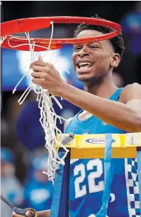  ?? JEFF ROBERSON THE ASSOCIATED PRESS ?? Hamilton native Shai Gilgeous-Alexander cuts down the net after Kentucky defeated Tennessee in the SEC championsh­ip.