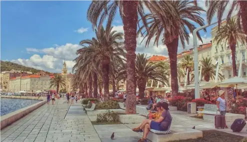  ?? ?? Wish you were here? Tourists enjoy the waterfront in Split, Croatia