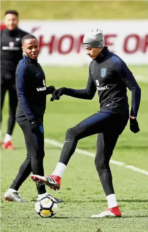  ??  ?? Calm before the storm: England’s Dele Alli (right) and Raheem Sterling at a training session at St George’s Park on Tuesday. — Reuters