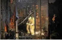  ?? VINNY TENNIS — DAILY LOCAL NEWS ?? Firefighte­rs work at the scene of a house fire at 694Churcht­own Road in Salisbury Township, Lancaster County early Wednesday morning. The fire, which was reported around 12:45a.m. destroyed the house.