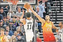  ?? [CHRIS NICOLL/THE ASSOCIATED PRESS] ?? Utah’s Rudy Gobert challenges the shot of San Antonio’s Bryn Forbes during Saturday’s game.