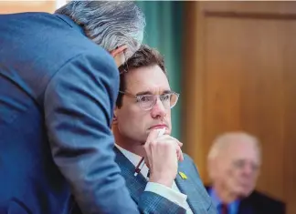  ?? EDDIE MOORE/JOURNAL ?? Sen. Gregg Schmedes, R-Tijeras, center, talks with Sen. David Gallegos, R-Eunice, during debate on a rural health care bill in the Senate Health and Public Affairs Committee on Monday.