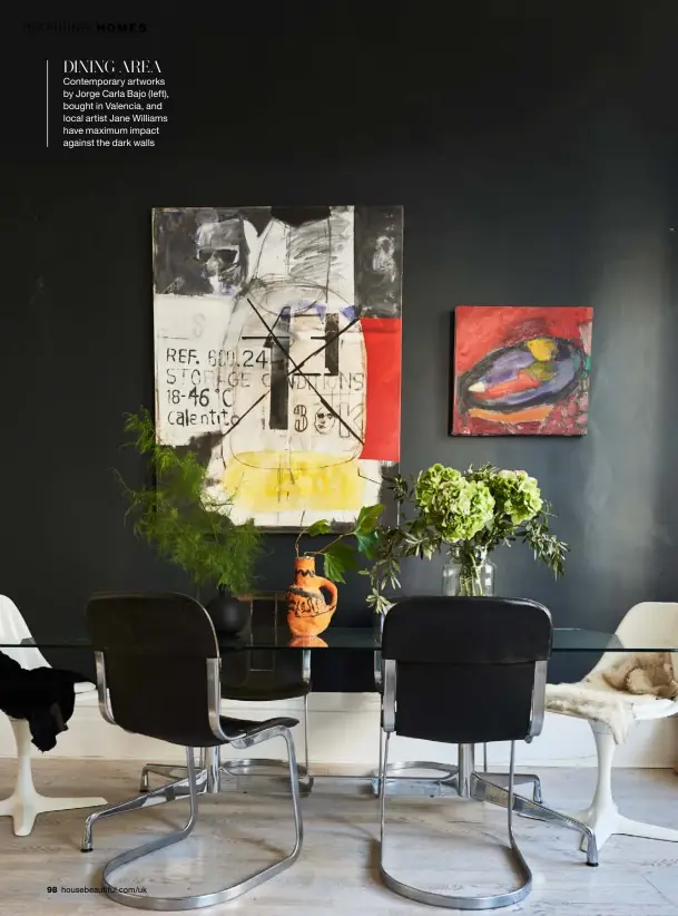  ??  ?? DINING AREA Contempora­ry artworks by Jorge Carla Bajo (left), bought in Valencia, and local artist Jane Williams have maximum impact against the dark walls