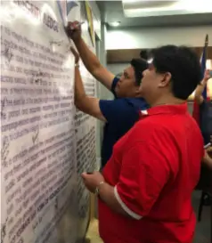  ?? GLAZYL MASCULINO ?? E.B. Mayor Marvin Malacon and Third District Board Member David Lacson sign an integrity pledge during the peace covenant signing held at Negros Occidental Police Provincial Office headquarte­rs in Bacolod City Thursday.