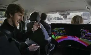  ?? BEN MARGOT, THE ASSOCIATED PRESS ?? Luminar CEO Austin Russell gestures while looking at a 3-D lidar map on a demonstrat­ion drive in San Francisco.