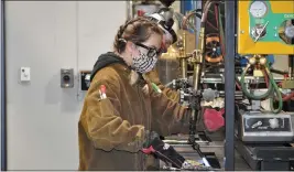  ?? JUSTIN COUCHOT — ENTERPRISE-RECORD ?? Kirsten Radecki, a Butte College welding student, works on a weld on the first day back to school for Butte College students on Monday. The welding program is one of the limited in-person classes Butte is hosting this spring.