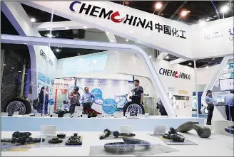  ?? (AP) ?? In this file photo, visitors tour the exhibition booth of ChemChina, also known as China National Chemical Corp, during the China Internatio­nal Chemical Industry Fair in Shanghai, China. US regulators have agreed to the Chinese conglomera­te’s proposed...