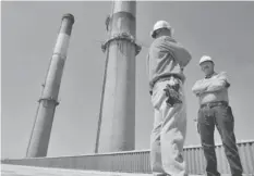  ?? THE ( NASHVILLE) TENNESSEAN ?? The Tennessee Valley Authority’s Thomas Cheney, left, and Larry Nathan stand on the roof of the Gallatin Fossil Plant.