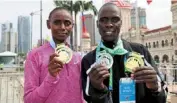  ?? — Bernama ?? Catch us if you can: Kenya’s Moses Kiptoo Kurgat and Shelmith Nyawira Muriuki posing with their top prizes.