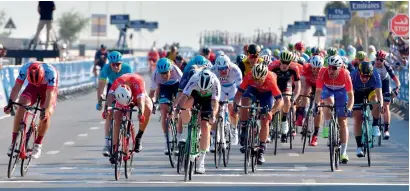  ?? — AFP ?? Dimension Data’s Mark Cavendish (centre) crosses the finish line to win the third stage of the Dubai Tour.