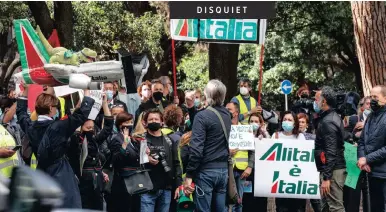  ?? | EPA ?? ITALIAN airline Alitalia employees in front of the State broadcaste­r RAI’s headquarte­rs, protesting against the government’s new plan to overhaul the flight company and the change of its name, in Rome, Italy, yesterday.