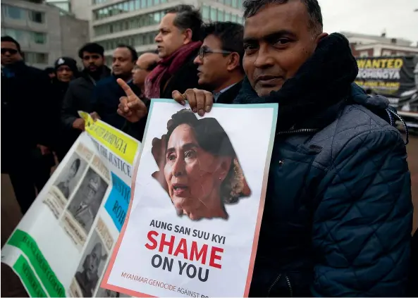  ?? AP ?? Protesters gather outside the Internatio­nal Court of Justice in The Hague as Myanmar’s leader Aung San Suu Kyi leads the defence against claims that her country waged genocide against Rohingya Muslims. Activists in Myanmar say they are ‘‘heartbroke­n’’ at the former human rights icon’s about-face.