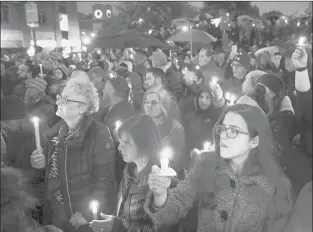  ?? MATT ROURKE | ASSOCIATED PRESS ?? PEOPLE hold candles as they gather for a vigil in the Squirrel Hill neighborho­od of Pittsburgh on Saturday in the aftermath of a deadly shooting at the Tree of Life Congregati­on.