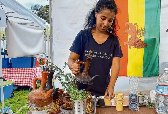  ?? Mario Cortez/The Chronicle ?? Yagere, a roaming Ethiopian coffee booth at Bay Area farmers’ markets, prepares Ethiopian-style coffee drinks.