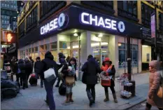  ?? AP LENNIHAN PHOTO/MARK ?? In this Jan. 14, 2015, file photo, people walk past a branch of Chase bank, in New York. JPMorgan Chase & Co. reports earnings Friday.