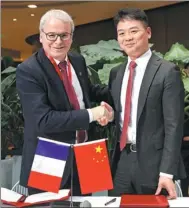  ?? AFP ?? Liu Qiangdong, CEO of JD, shakes hands with Fives Group Chairman Frederic Sanchez after signing an agreement in Beijing.