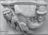  ?? YALE UNIVERSITY VIA AP ?? In this July 20, 2017 photo provided by Yale University, a 1929 doorway carving on the school’s New Haven campus depicts a Puritan settler, right, with a musket pointing at the head of a Native American, left, which had been covered by workers with...