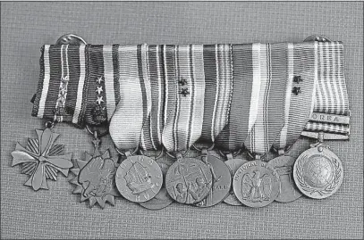  ?? TOM DODGE/DISPATCH ?? John Glenn was one decorated Marine. Here are dress-uniform versions of the service medals awarded to him during his career in the Marine Corps, including, on the left, the Distinguis­hed Flying Cross (awarded six times) and the Air Medal (awarded 18...