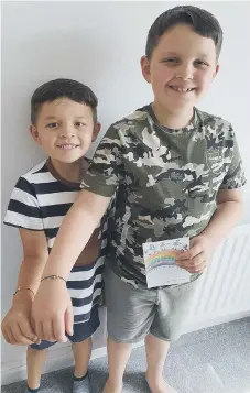  ??  ?? Toby Medhurst, right, and brother Sam wearing rainbow wish bracelets.