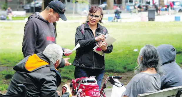 ?? NICK PROCAYLO/PNG ?? Phyllis Fleury, who came from Prince George to look for her 16-year-old son Colten, hands out flyers in Vancouver on Thursday.
