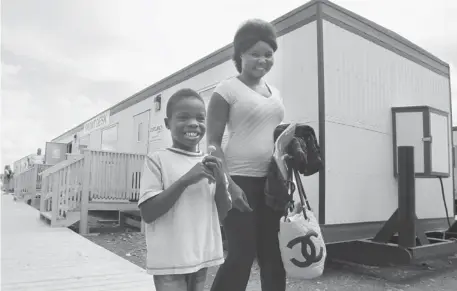  ?? Lorraine Hjalte/calgary Herald ?? Natalina Katas and her son, Joseph Pasquale, 6, are some of the first to arrive Wednesday at Saddlebroo­k Camp, a temporary home for High River residents who have none after the Highwood River flooded last month.