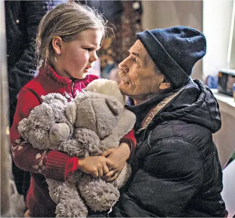  ?? ?? Alina says goodbye to her grandfathe­r in Bakhmut before being driven to a reunion with her mother in Ukrainian-held territory