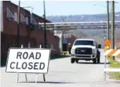  ??  ?? Maple Street is closed Monday at Cate Avenue in front of the Coats American building in Rossville.