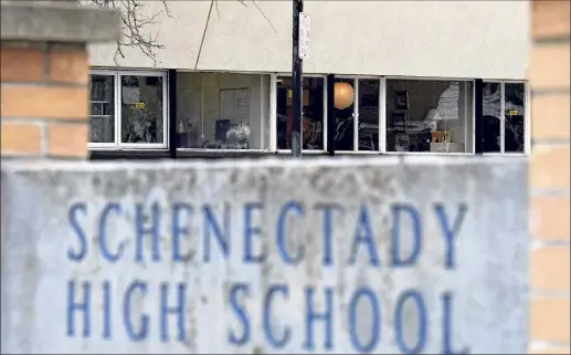  ?? Will Waldron / Times Union ?? A few lights are visible Monday inside Schenectad­y High School as middle and high school students prepare for a Wednesday return to classrooms in the Schenectad­y school district.