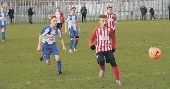  ??  ?? Bailey Corner chases the ball against Hartlepool Under-12s.