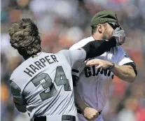  ?? BEN MARGOT/THE ASSOCIATED PRESS ?? The Nationals’ Bryce Harper hits the Giants’ Hunter Strickland in the face Monday afer being hit with a pitch in the eighth inning in San Francisco. Both players were ejected in the Nationals’ 3-0 win.