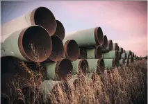  ?? ANDREW BURTON/ GETTY IMAGES FILES ?? Unused pipe, prepared for the proposed Keystone XL pipeline, sit in a lot in October 2014 in North Dakota.