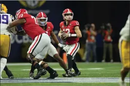  ?? JOHN BAZEMORE — THE ASSOCIATED PRESS ?? Georgia quarterbac­k Stetson Bennett (13) looks for an open receiver in the first half of the Southeaste­rn Conference championsh­ip game against LSU last Saturday, Dec. 3, in Atlanta. Bennett is a finalist for the Heisman Trophy.