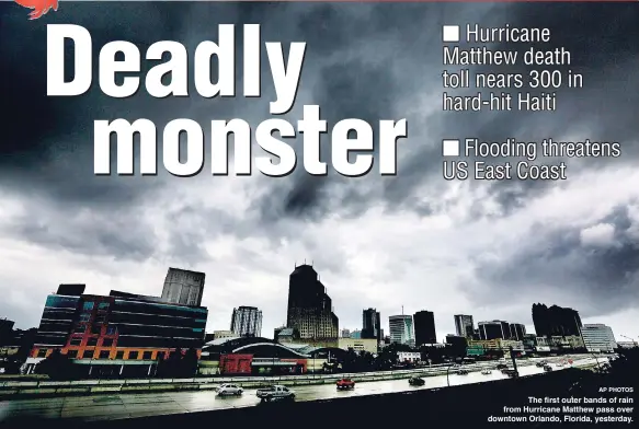  ?? AP PHOTOS ?? The first outer bands of rain from Hurricane Matthew pass over downtown Orlando, Florida, yesterday.