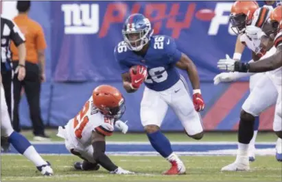  ?? JOHN BLAINE/ FOR THE TRENTONIAN ?? Giants running back Saquon Barkley carries the ball against the Browns in the team’s preseason opener. Barkley picked up a knock during camp and may not play again until the season opener.